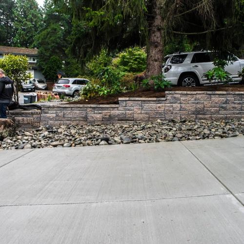  | A new "broom finish" concrete driveway with an Allan Block Wall (Rocky Mountain Blend, Ashlar Pattern) and some beautiful river rock to tie it all in. | Retaining Walls & Borders - Design and Installation 